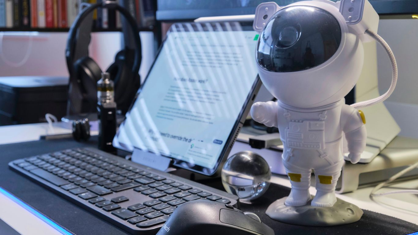 a robot standing next to a laptop