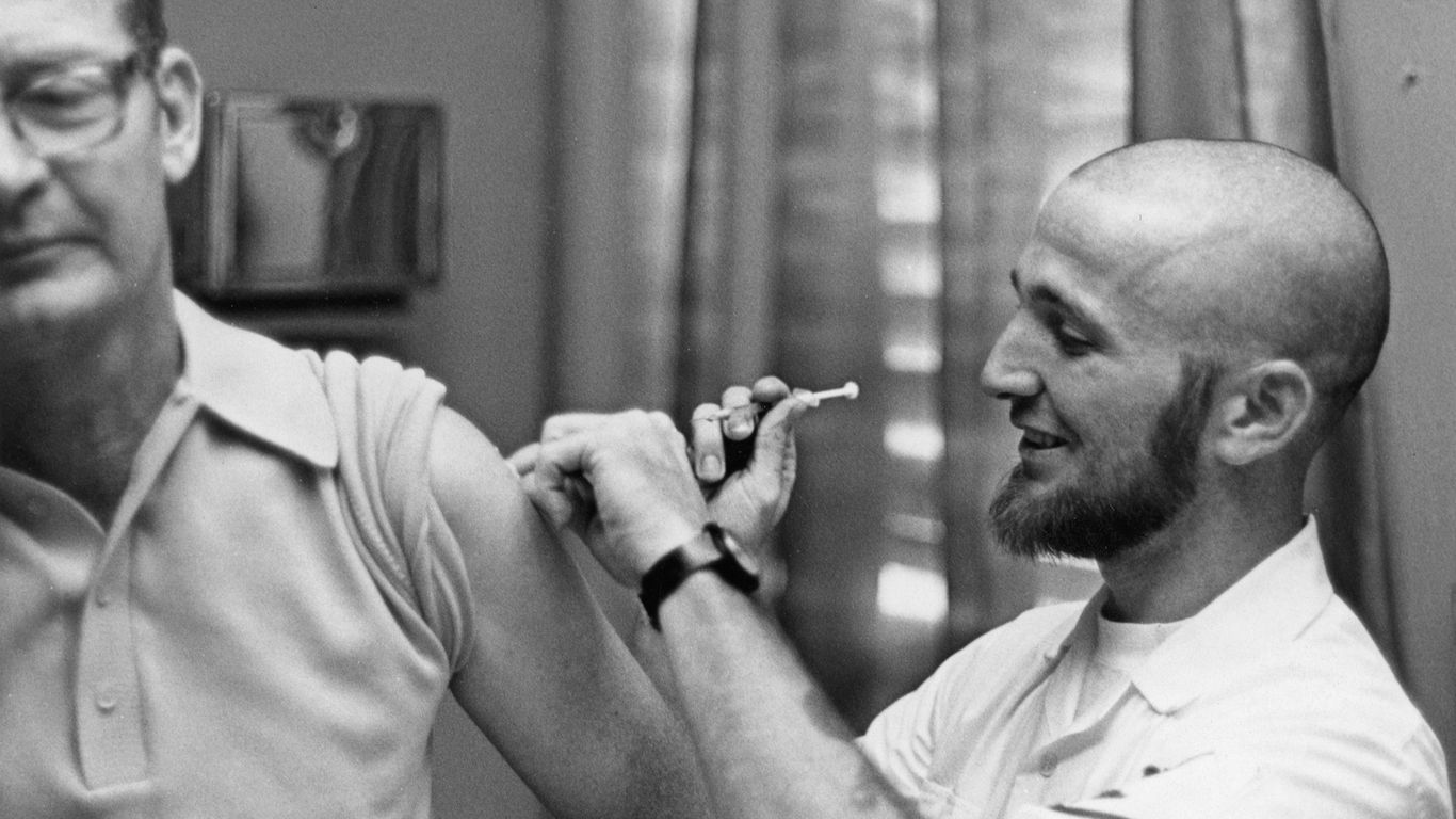 Doctor gives patient a vaccine shot