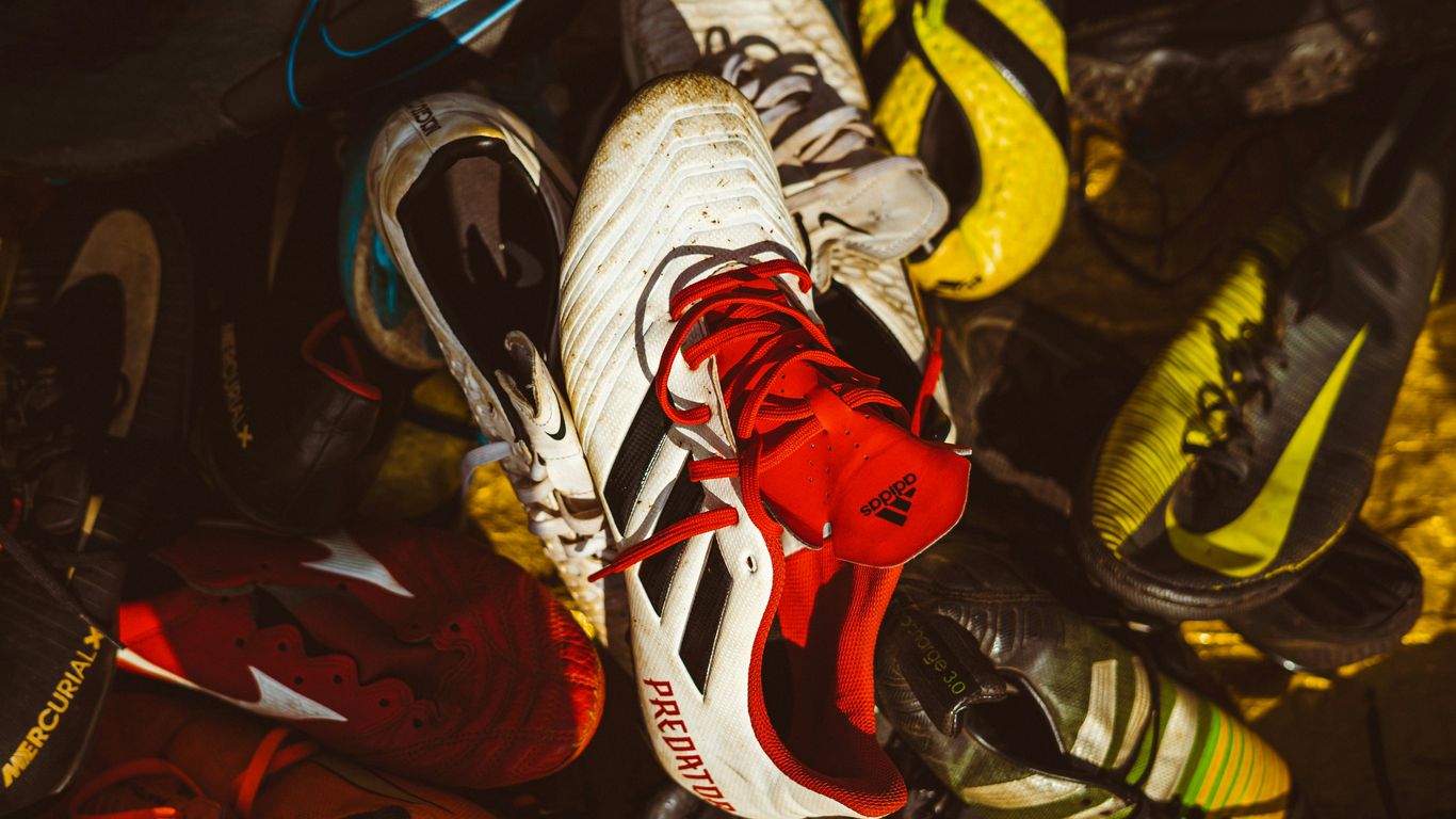 A bunch of shoes that are laying on the ground