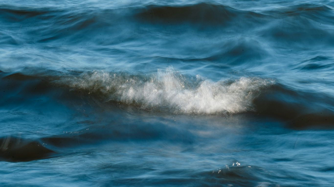 Blue ocean waves with white foam