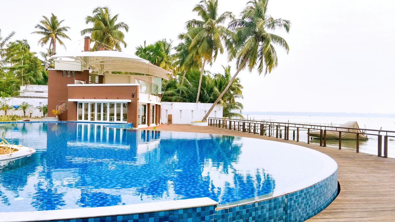 swimming pool near palm trees during daytime
