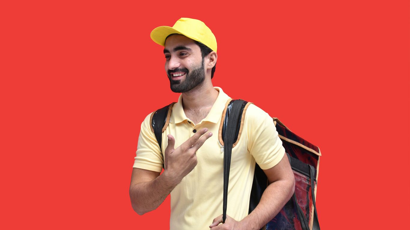 a man with a beard and a yellow hat with a backpack