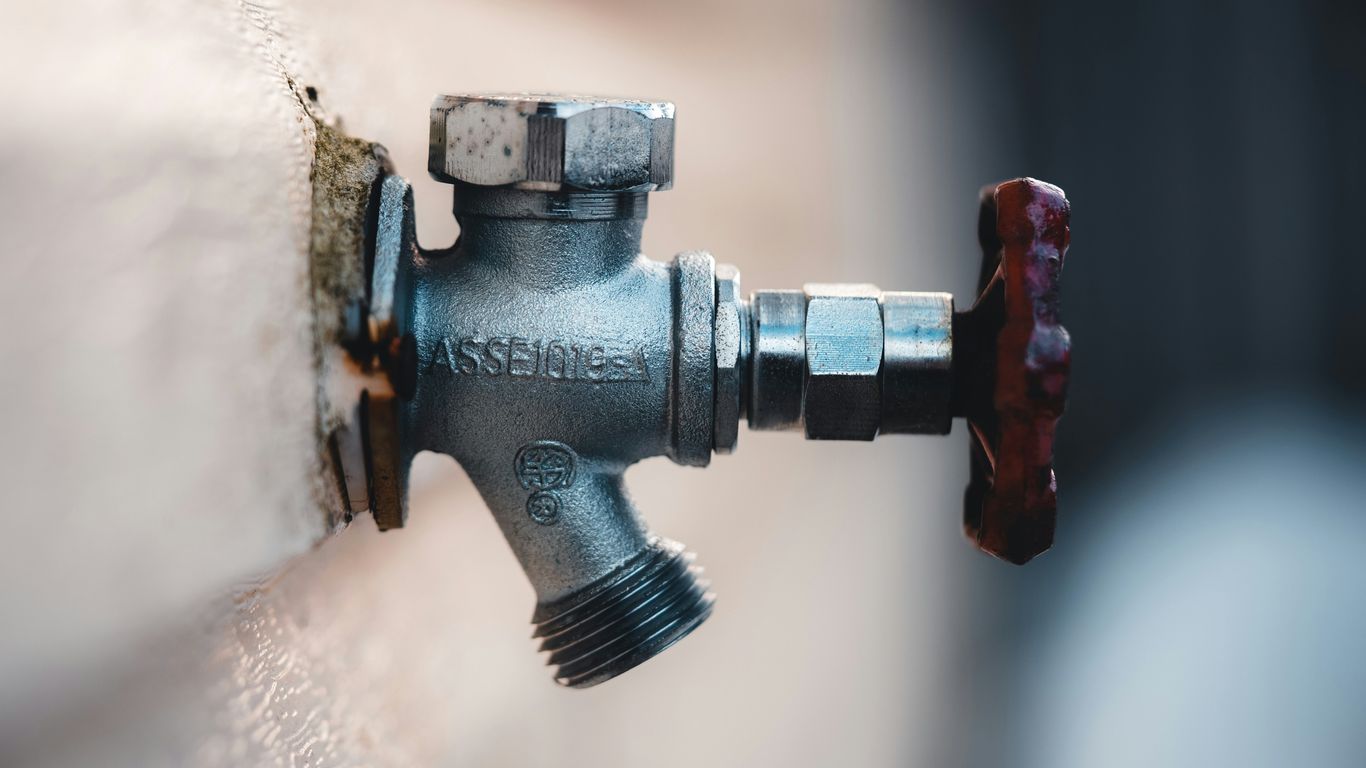 a close up of a water faucet attached to a wall