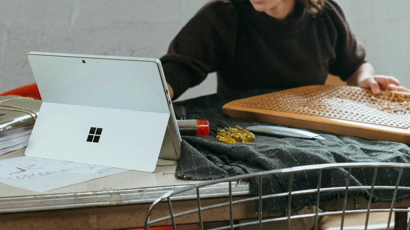 a woman sitting at a table with a laptop
