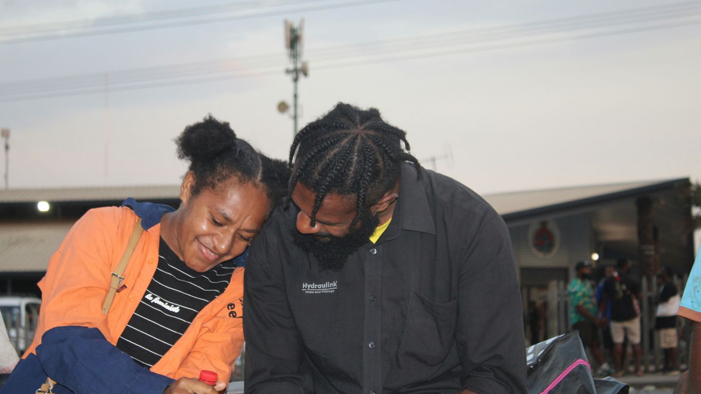 a couple of people that are looking at something