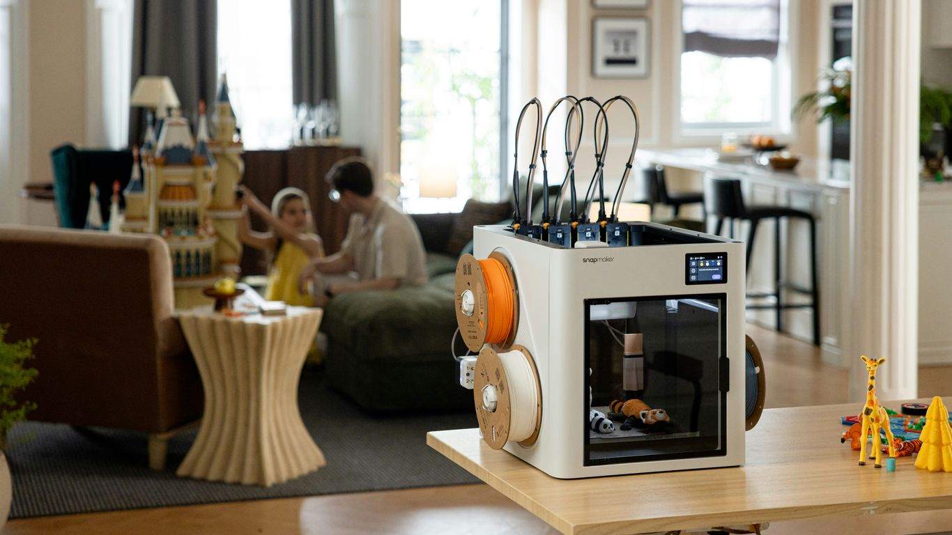 3D printer with filament rolls in a modern living room