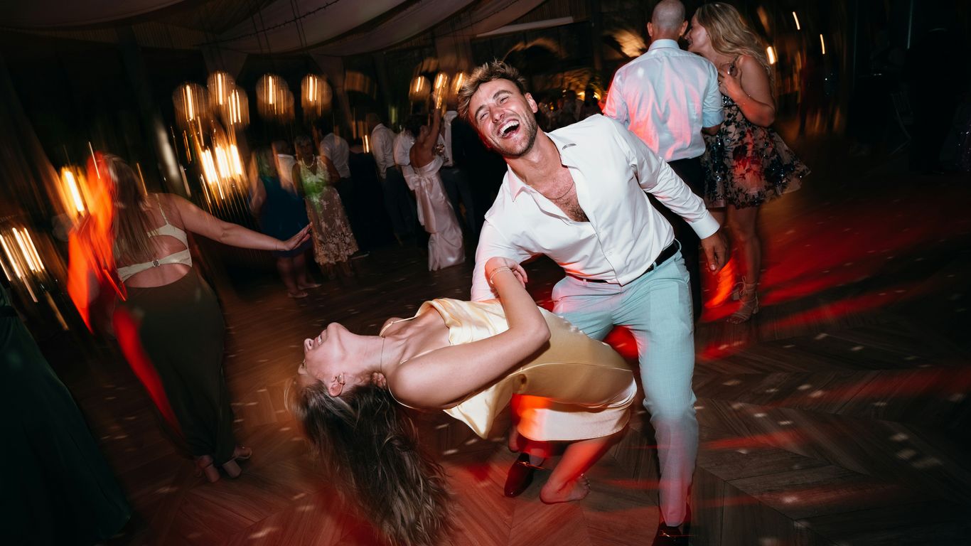 Couple dancing joyfully at a lively outdoor party