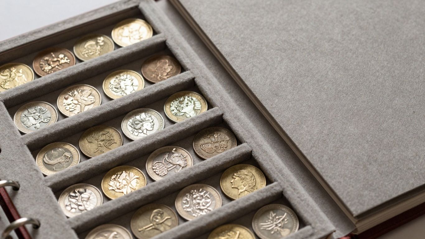 Open coin album with various coins inside.