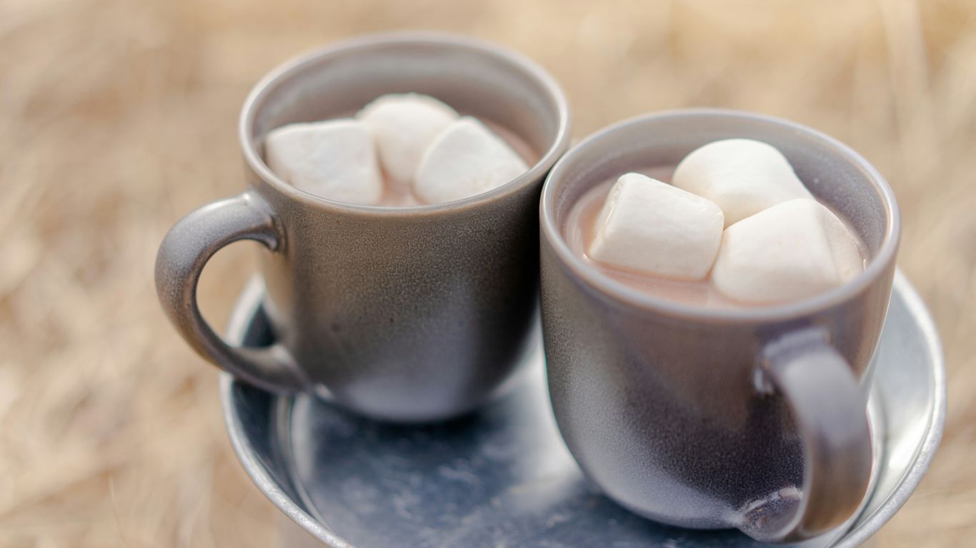 two mugs of beverages and marshmallows