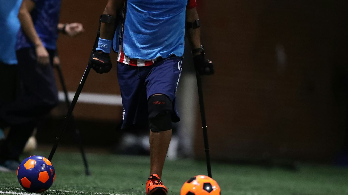 shallow focus photo of person using black crutches