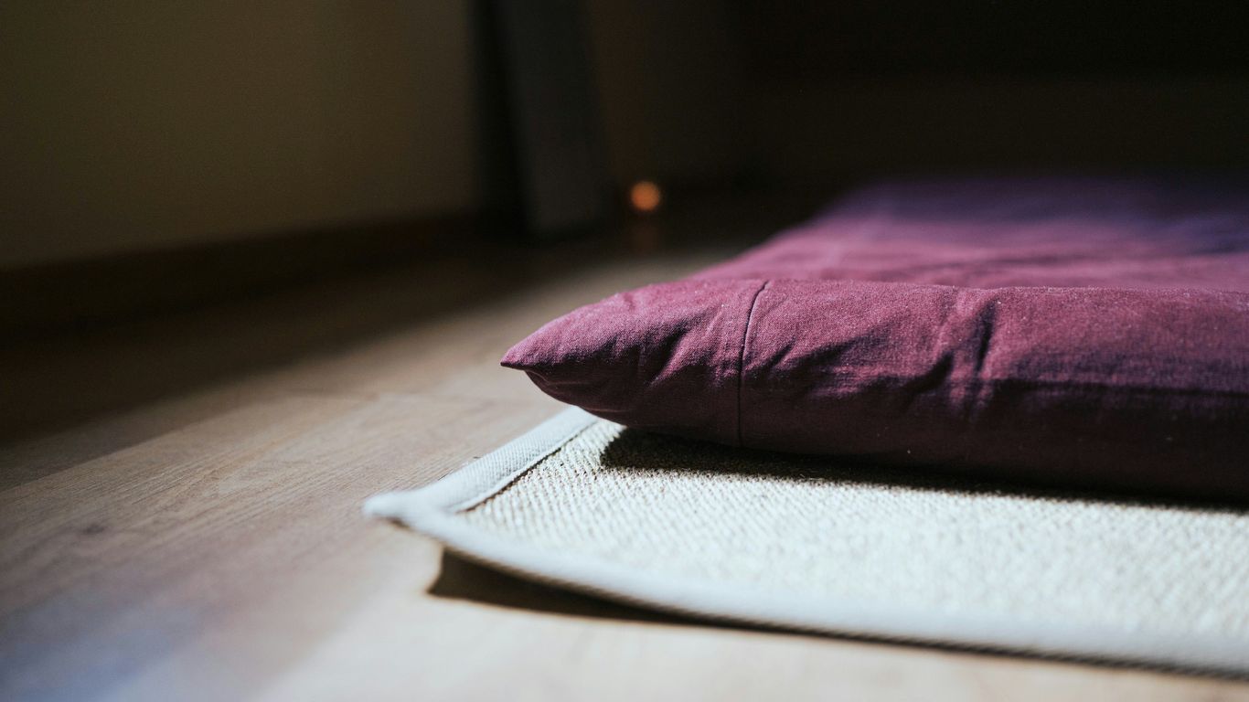 purple throw pillow on white book page
