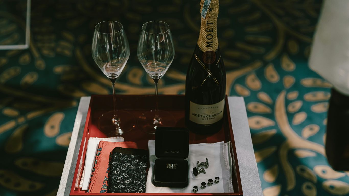 a tray with two wine glasses and a bottle of wine