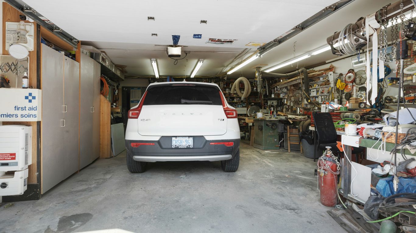 a white car is parked in a garage