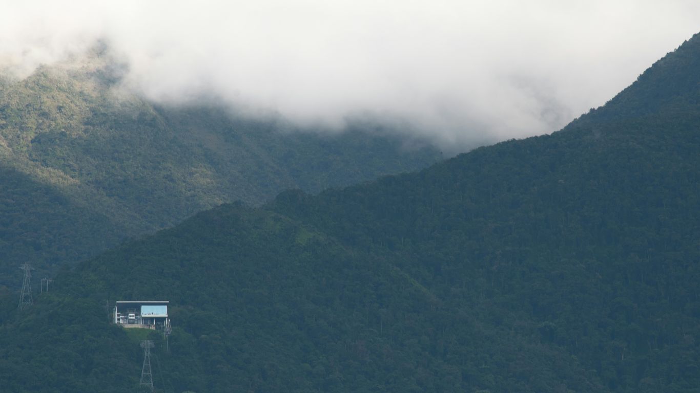 a house in the middle of a mountain range