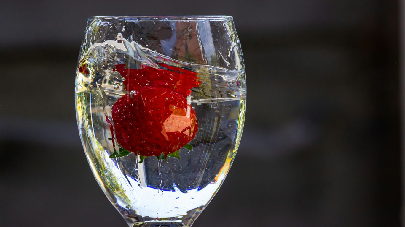 red strawberry in clear glass