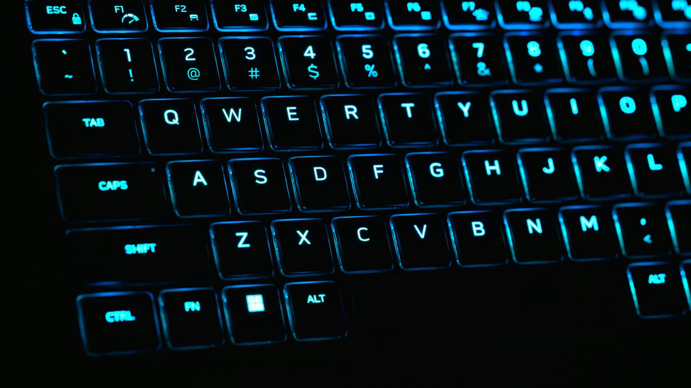 a close up of a keyboard with blue lights