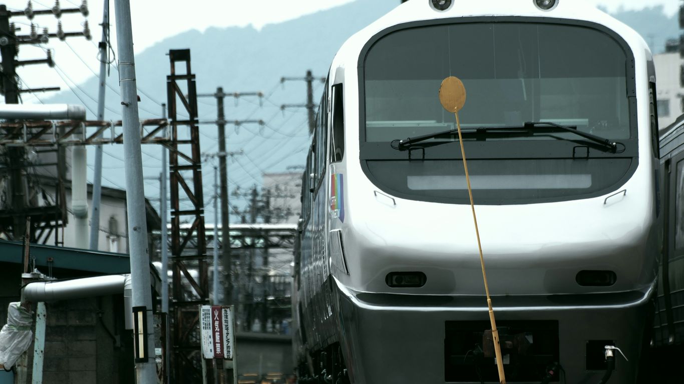 white train on rail tracks during daytime