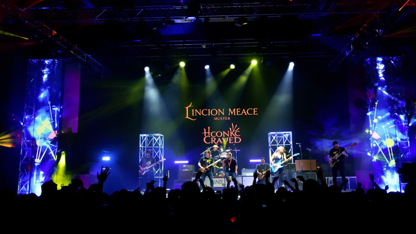 Band performing live music on a stage with colorful lights.