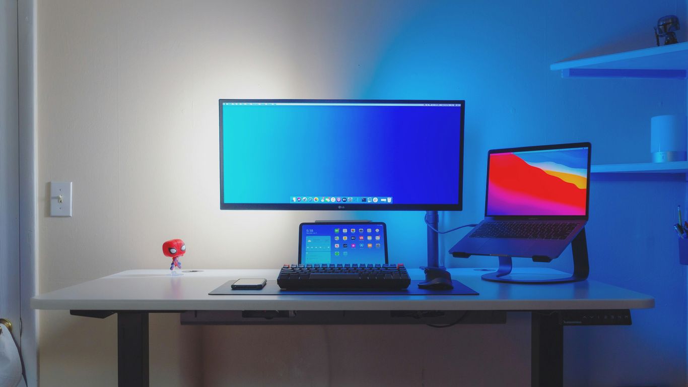 black flat screen computer monitor on white wooden desk