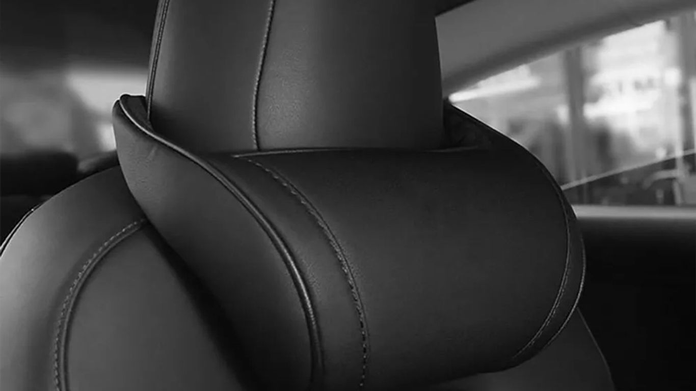 Black leather car seat headrest with a sleek design.