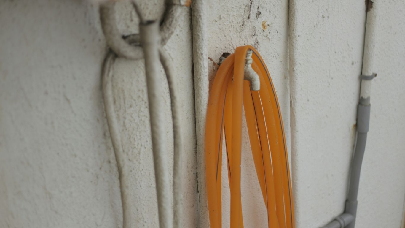 A bunch of orange cords hanging on a wall