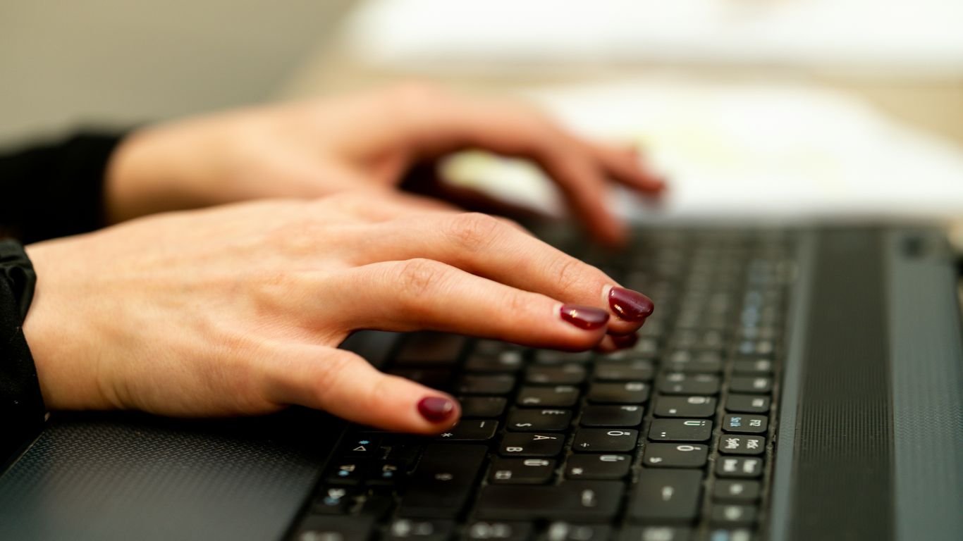 persons hand on black laptop computer