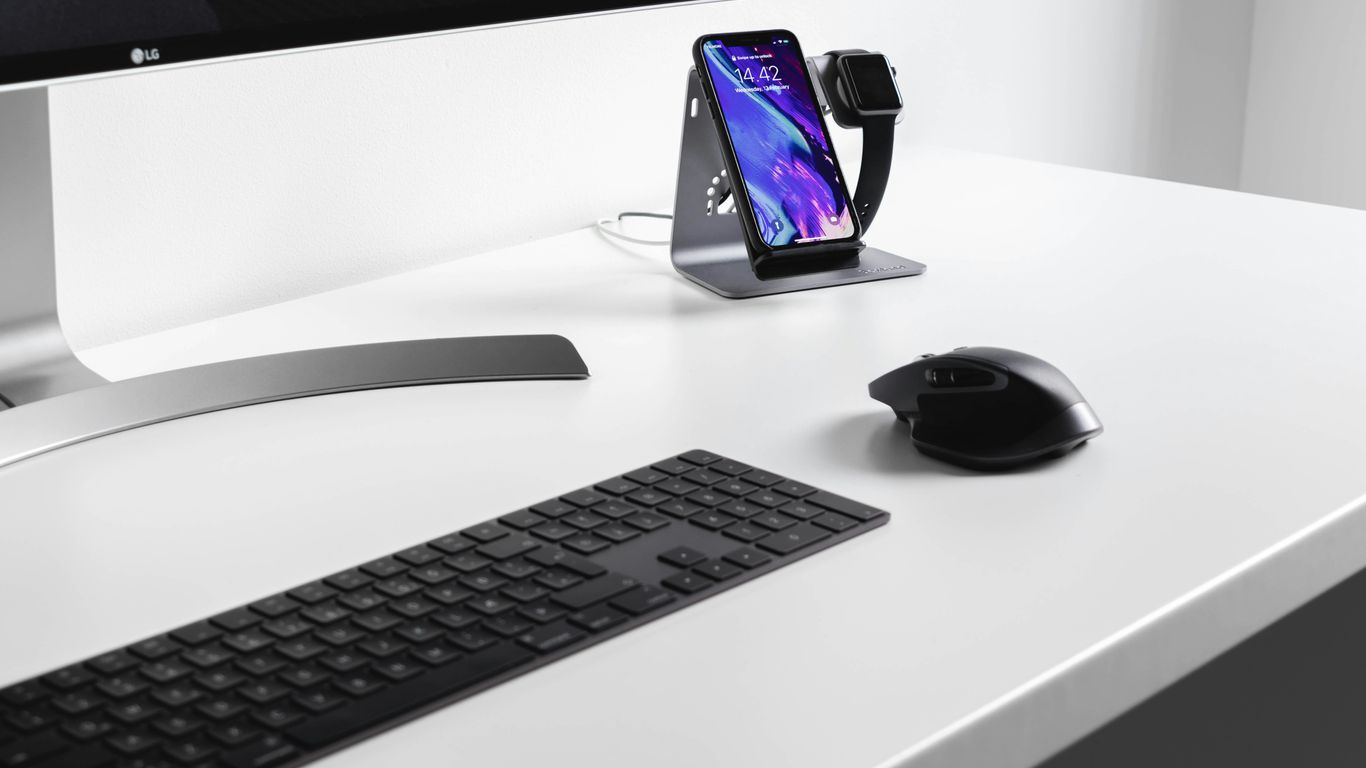 black cordless mouse and keyboard on white wooden table