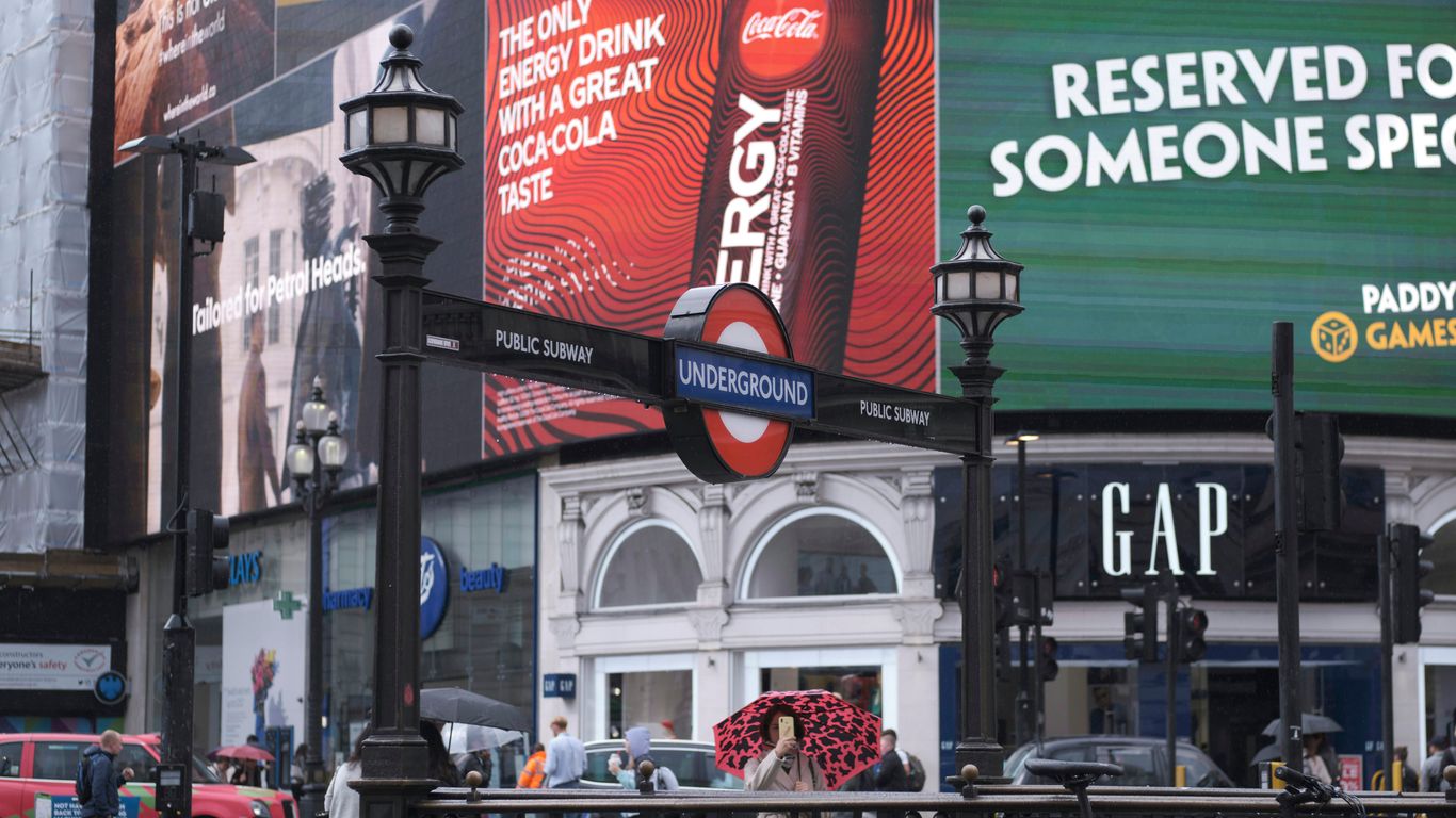 black metal fence near red and white building
