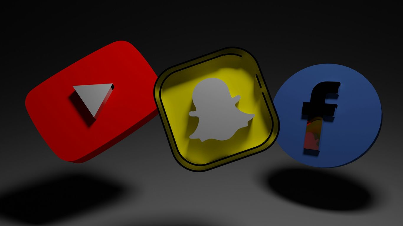 a group of three different colored objects on a black background