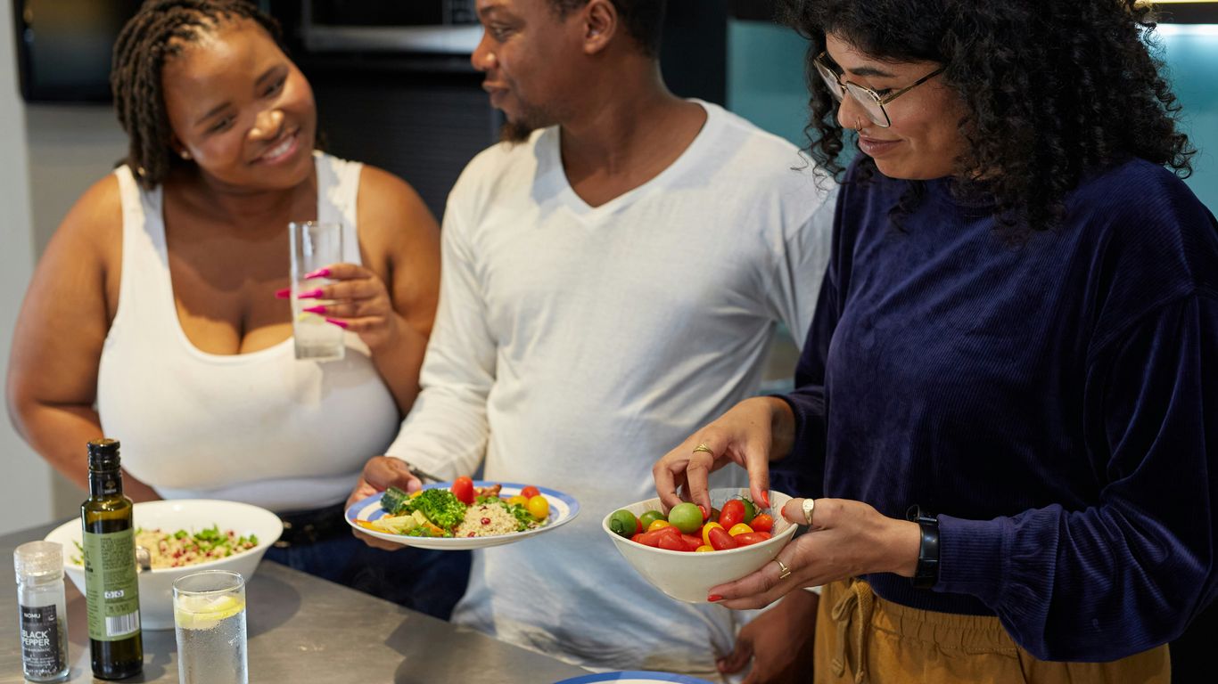 a group of people preparing food in a kitchen