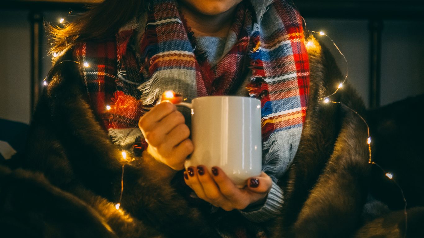 shallow focus photo of person wearing white ceramic mug