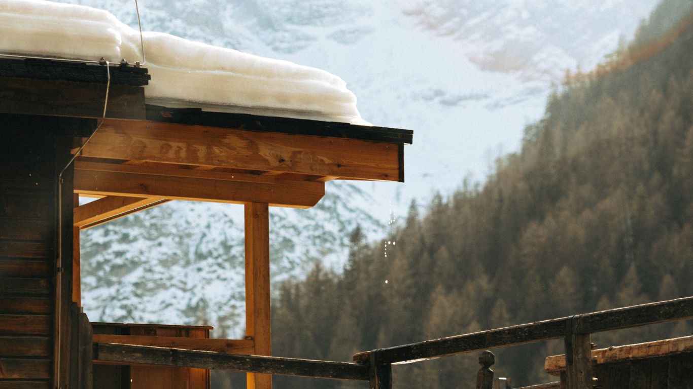 a wooden structure with snow on top of it