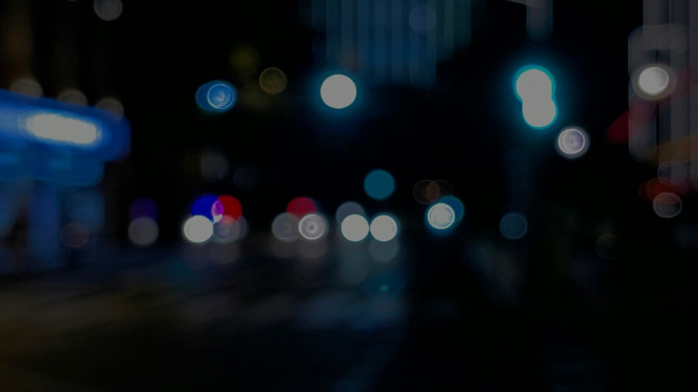 a blurry photo of a city street at night