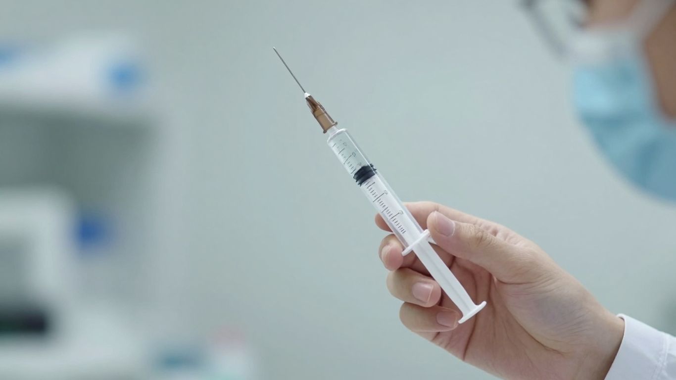 Medical professional with syringe for weight loss treatment.