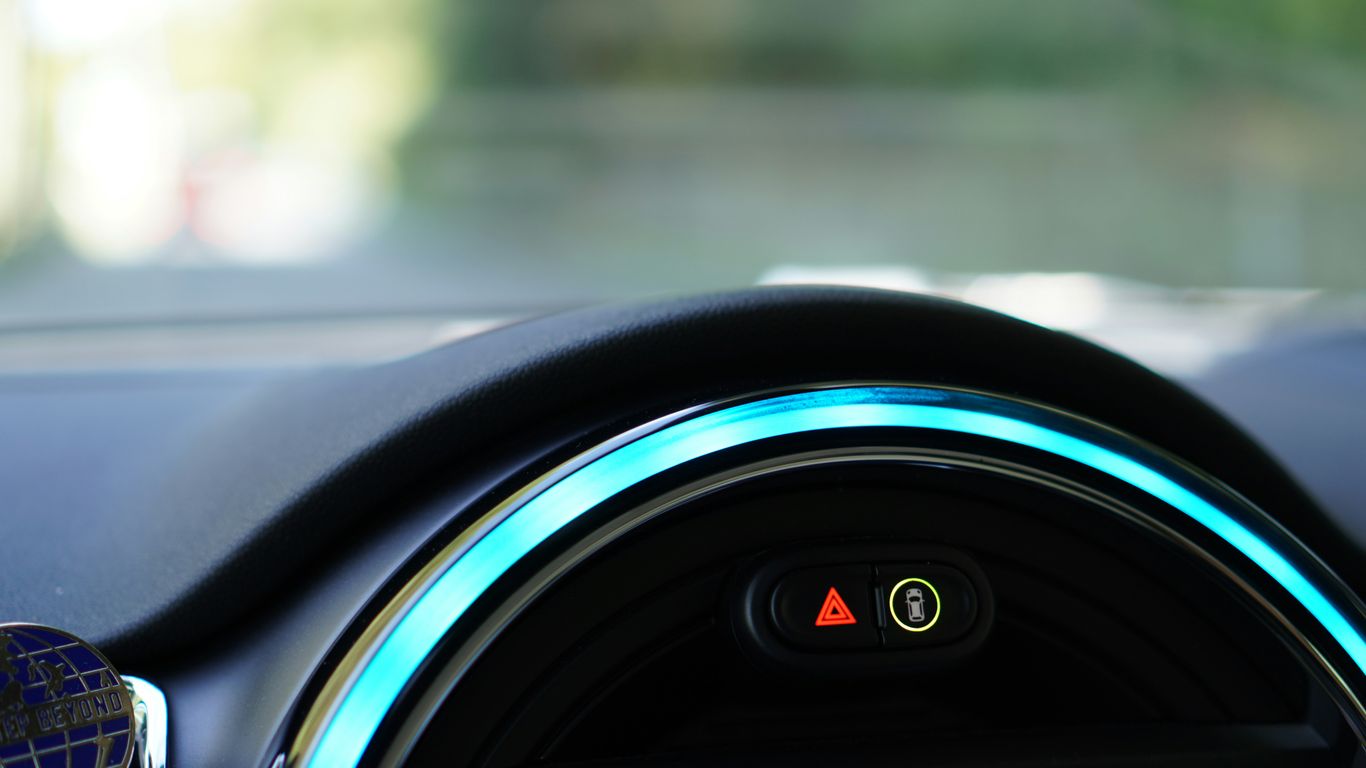 a close up of a car dashboard with a blue light