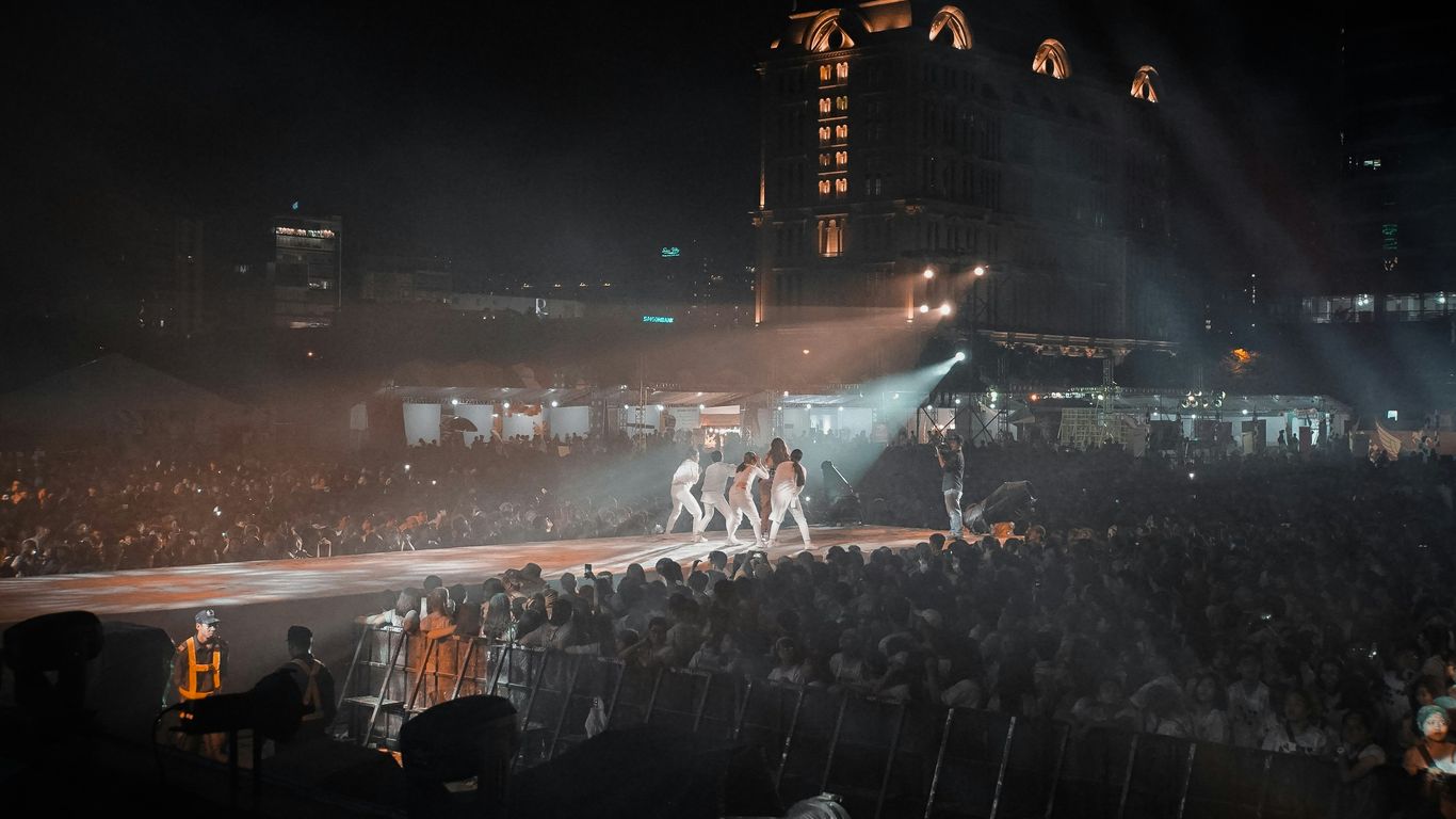 people watching a band performing on stage during nighttime