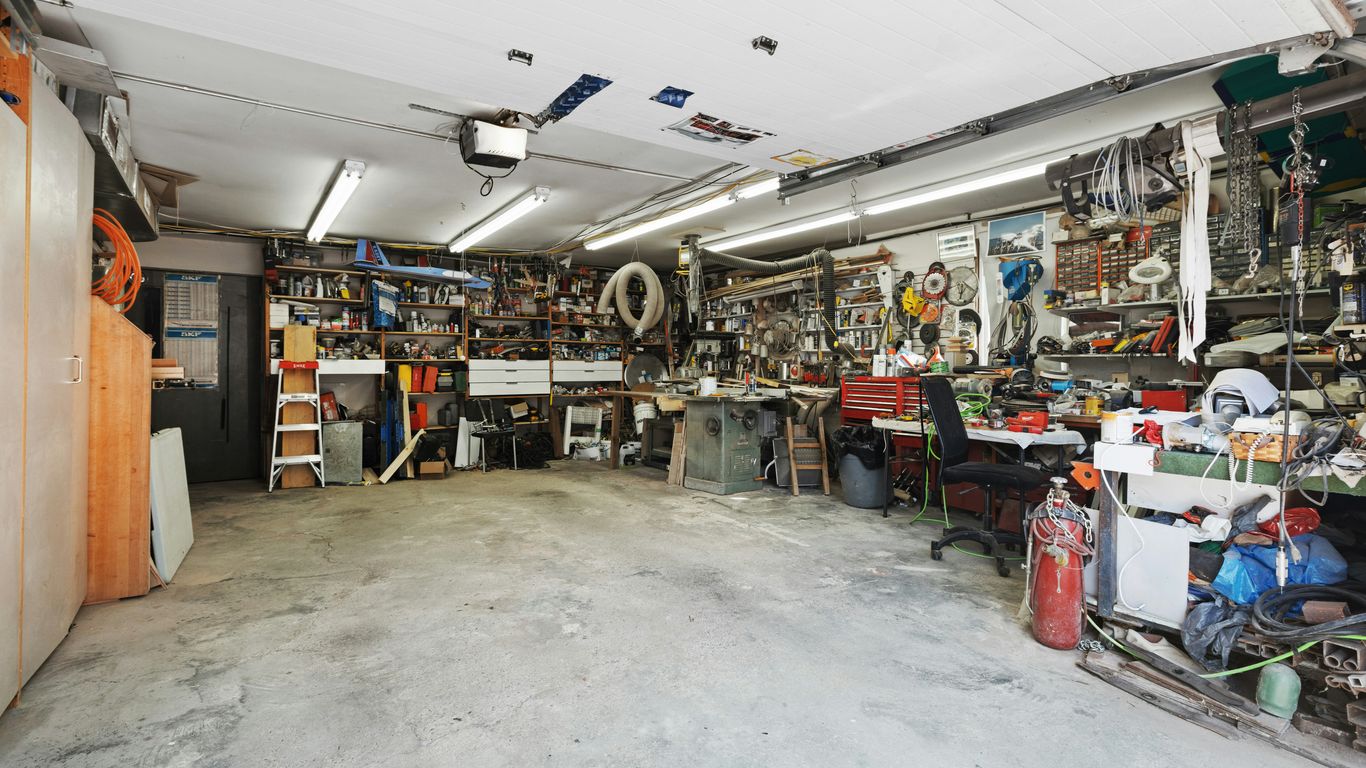 a garage filled with lots of clutter and tools