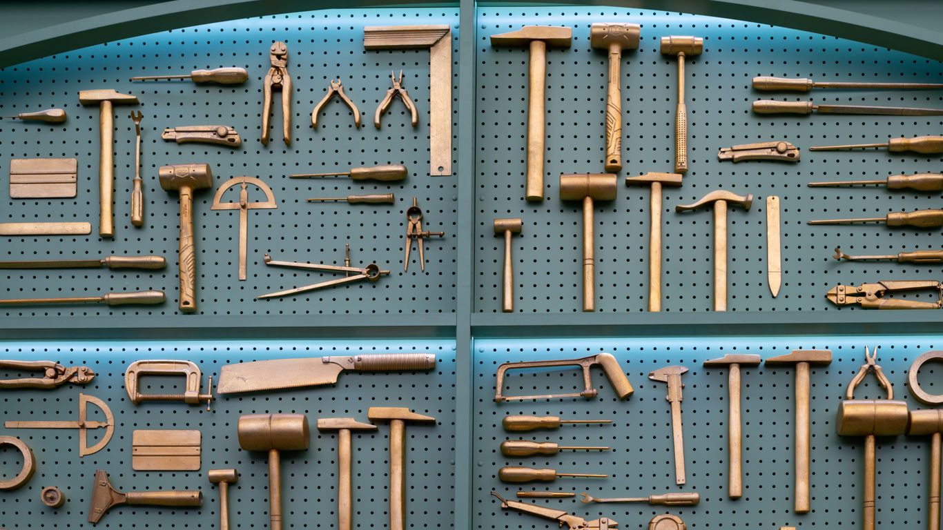 Collection of various brass woodworking tools displayed neatly.