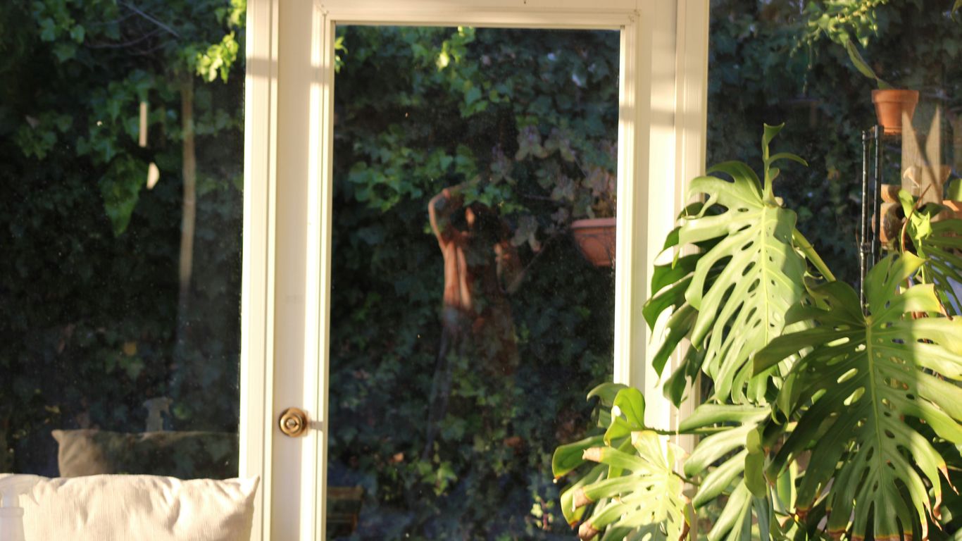 a window with a reflection of a woman in it