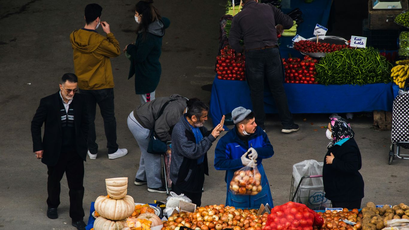people standing on street with fruits and vegetables