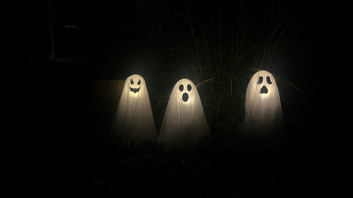 three ghostly ghost figures in the dark