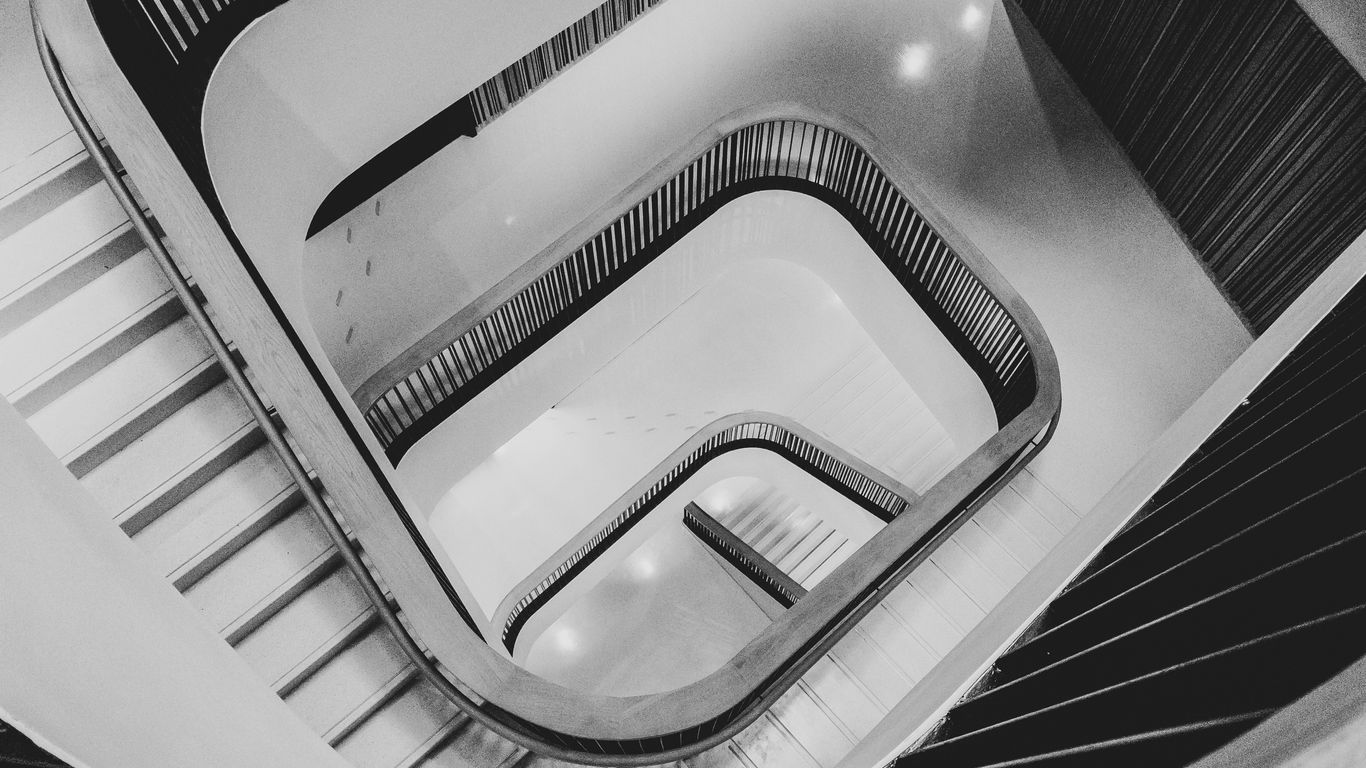 a black and white photo of an escalator