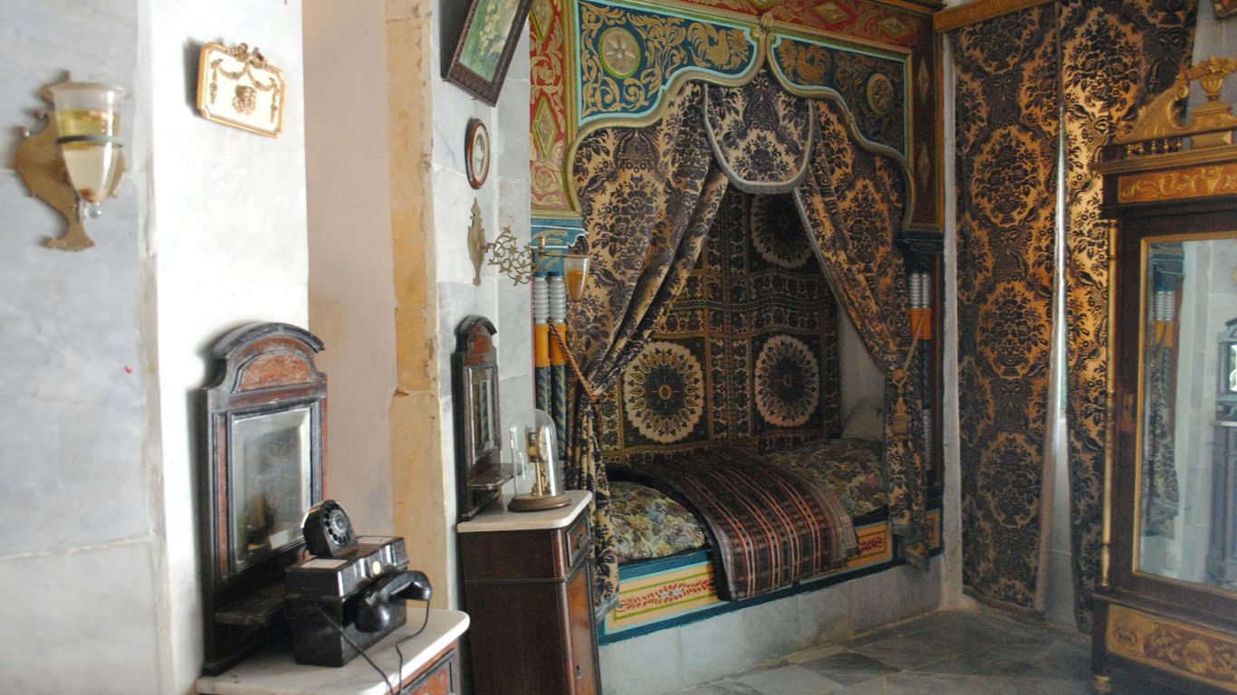 brown wooden framed brown and beige floral padded armchair