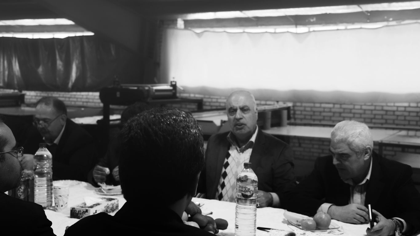 grayscale photo of men eating