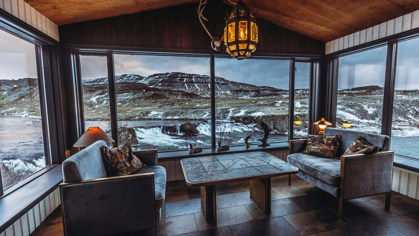 a living room filled with furniture and a large window