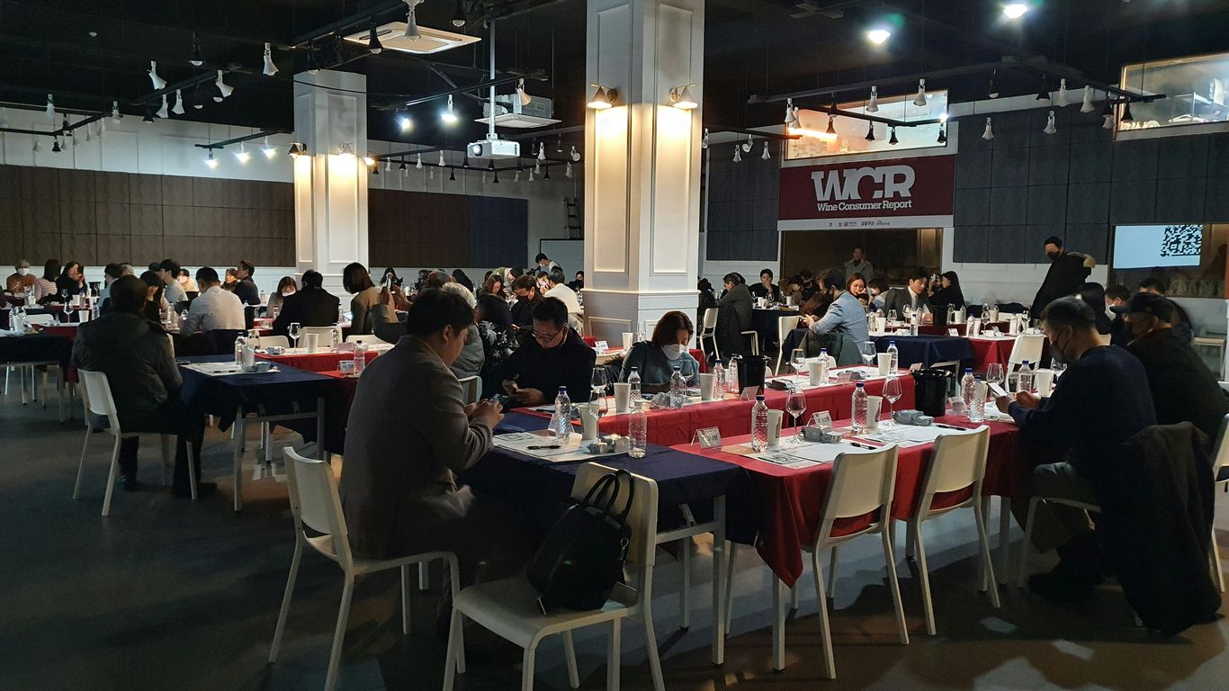 a group of people sitting at tables in a room