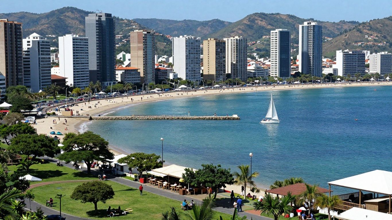 Adelaide harbor with sailboats and city skyline.