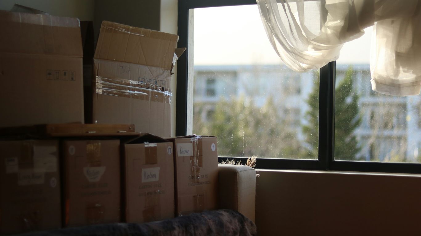 a room with boxes and a window