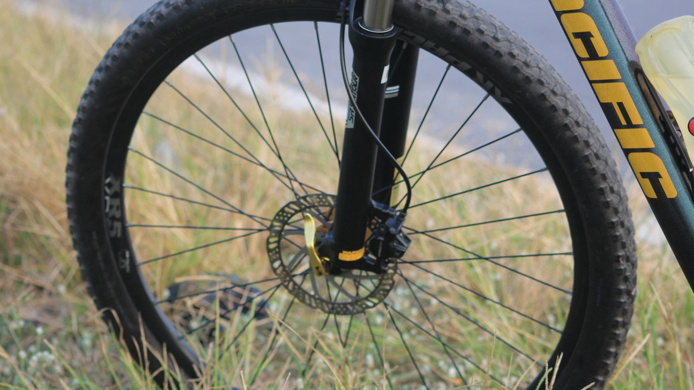 A close up of a bike parked on the side of a road