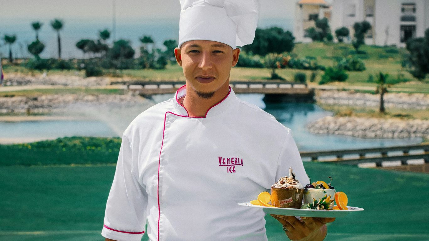 woman in white chef uniform holding green plate with food